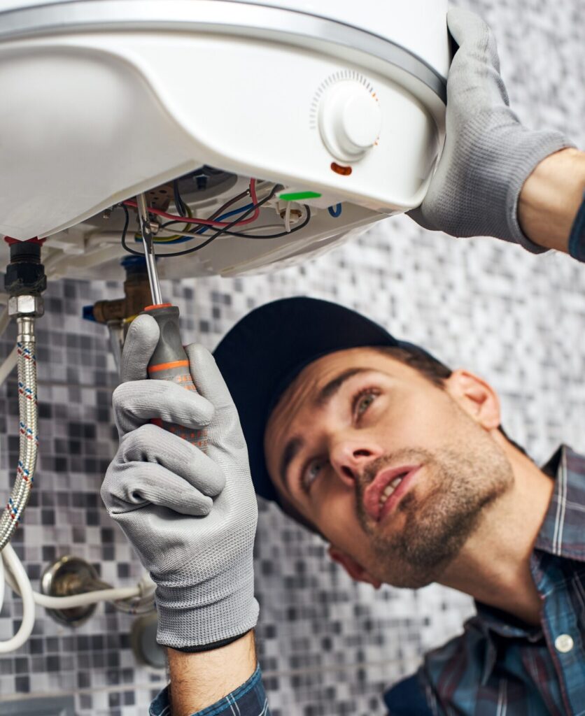 Set up boiler. Worker set up electric heating boiler at home bathroom